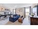 Well-lit living room featuring a modern sofa, stylish coffee table, and two desks at 673 Sun Meadow Dr, Wake Forest, NC 27587