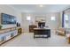 Well-lit home office with wooden desk, console, decor, and chairs set atop light rug at 673 Sun Meadow Dr, Wake Forest, NC 27587