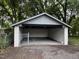 Open carport with ample space and a gated entrance, nestled among mature trees at 722 Long Ave, Rocky Mount, NC 27801