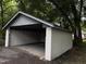 Open carport with ample space and a gated entrance, nestled among mature trees at 722 Long Ave, Rocky Mount, NC 27801