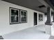 Inviting front porch with newly painted textured walls and framed windows at 722 Long Ave, Rocky Mount, NC 27801