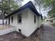 Exterior side view of a freshly painted white home featuring new windows and an open porch at 722 Long Ave, Rocky Mount, NC 27801