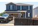 New construction two-story home featuring navy siding, black shutters, and an attached two-car garage at 722 White Birch Ln, Angier, NC 27501