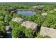 Scenic aerial view of homes nestled by a serene lake surrounded by lush greenery at 8231 Allyns Landing Way # 101, Raleigh, NC 27615
