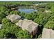 Scenic aerial view of homes nestled by a serene lake surrounded by lush greenery at 8231 Allyns Landing Way # 101, Raleigh, NC 27615