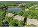 Scenic aerial view of homes nestled by a serene lake surrounded by lush greenery at 8231 Allyns Landing Way # 101, Raleigh, NC 27615