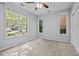 Bright bedroom with multiple windows, neutral carpet, and a ceiling fan at 8231 Allyns Landing Way # 101, Raleigh, NC 27615