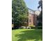 Exterior of a brick apartment building with a well-manicured lawn and lush greenery at 8231 Allyns Landing Way # 101, Raleigh, NC 27615