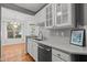 Galley kitchen featuring granite counters, stainless appliances, tile backsplash and open to dining area at 8231 Allyns Landing Way # 101, Raleigh, NC 27615