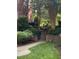 Walkway and stairs leading up to the building with lush, mature landscaping at 8231 Allyns Landing Way # 101, Raleigh, NC 27615