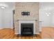 Living room with stone fireplace, mantle and hearth, and hardwood flooring at 8231 Allyns Landing Way # 101, Raleigh, NC 27615