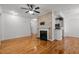 Spacious living room featuring hardwood floors, fireplace, and bright lighting at 8231 Allyns Landing Way # 101, Raleigh, NC 27615