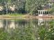 Scenic pond view with a white gazebo on the edge of the pond and reflection of the trees at 8231 Allyns Landing Way # 101, Raleigh, NC 27615
