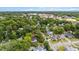 An aerial view of a charming town nestled within lush green trees, showcasing a mix of residential and commercial buildings at 830 S Chestnut St, Henderson, NC 27536