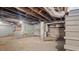 Basement featuring brick walls, exposed utilities, and concrete floors at 830 S Chestnut St, Henderson, NC 27536