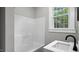Well-lit bathroom featuring a bathtub and vanity, creating a functional and tidy space at 830 S Chestnut St, Henderson, NC 27536