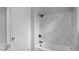 Bathroom features marble tile surround and a shower-tub combo at 830 S Chestnut St, Henderson, NC 27536