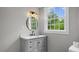 Stylish bathroom with a classic vanity, marble countertop, and ample natural light, blending elegance and functionality at 830 S Chestnut St, Henderson, NC 27536