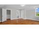 Bedroom featuring hardwood floors with ensuite bathroom, offering comfort and convenience at 830 S Chestnut St, Henderson, NC 27536