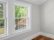 Bedroom with neutral walls and hardwood floors with double windows at 830 S Chestnut St, Henderson, NC 27536