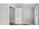 Bright room featuring hardwood floors, white trim, and multiple doors at 830 S Chestnut St, Henderson, NC 27536