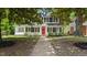 Traditional two-story home with a red front door and manicured landscaping at 830 S Chestnut St, Henderson, NC 27536