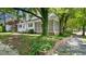 Charming two-story home with a screened-in porch and mature trees at 830 S Chestnut St, Henderson, NC 27536