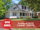 Charming two-story traditional home featuring black shutters, lush green lawn and Open House banner at 830 S Chestnut St, Henderson, NC 27536