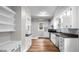 Charming kitchen with white cabinetry, stainless steel appliances, and a glass tile backsplash at 830 S Chestnut St, Henderson, NC 27536