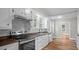Modern kitchen with stainless steel appliances, wood countertops, and white cabinetry at 830 S Chestnut St, Henderson, NC 27536