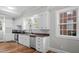 Well-lit kitchen featuring stainless steel appliances, wood countertops, and ample storage space at 830 S Chestnut St, Henderson, NC 27536
