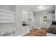 Bright kitchen includes ample counter space, white cabinetry, and built in shelving at 830 S Chestnut St, Henderson, NC 27536