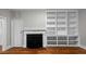 Cozy living room featuring a fireplace and built-in shelving, perfect for storage and display at 830 S Chestnut St, Henderson, NC 27536