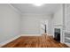 Living room featuring hardwood flooring, modern fireplace, and built in shelving at 830 S Chestnut St, Henderson, NC 27536