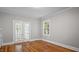 Inviting living area features glass doors allowing natural light to fill the space with hardwood floors at 830 S Chestnut St, Henderson, NC 27536