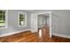 Spacious room with gleaming hardwood floors, glass doors and windows that let in natural light at 830 S Chestnut St, Henderson, NC 27536