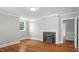 Inviting living room with a classic fireplace, hardwood floors, and abundant natural light, perfect for relaxing and entertaining at 830 S Chestnut St, Henderson, NC 27536
