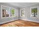 Sun-drenched living space with hardwood floors and multiple windows creates a warm and inviting atmosphere at 830 S Chestnut St, Henderson, NC 27536