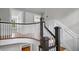 Bright staircase with white banisters and wood stairs leading to the second floor at 830 S Chestnut St, Henderson, NC 27536