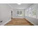 Bright sunroom features plank flooring and many windows offering natural light at 830 S Chestnut St, Henderson, NC 27536