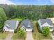 An aerial view showcasing the well-manicured lawns of homes in a neighborhood with mature trees at 850 Apalachia Lake Dr, Fuquay Varina, NC 27526