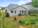 Backyard featuring a screened-in porch, a garden, and a neatly landscaped yard at 850 Apalachia Lake Dr, Fuquay Varina, NC 27526