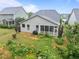 Backyard featuring a screened-in porch, a garden, and a neatly landscaped yard at 850 Apalachia Lake Dr, Fuquay Varina, NC 27526