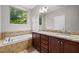 Bathroom includes a double sink vanity, granite countertop, and a soaking tub at 850 Apalachia Lake Dr, Fuquay Varina, NC 27526