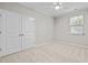 Bedroom featuring a window, a ceiling fan and a double-door closet at 850 Apalachia Lake Dr, Fuquay Varina, NC 27526