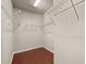 Walk-in closet provides ample storage space with built-in wire shelving and hardwood floors at 850 Apalachia Lake Dr, Fuquay Varina, NC 27526