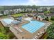 Aerial view of a large community pool area with ample lounge chairs, tables, and playground equipment at 850 Apalachia Lake Dr, Fuquay Varina, NC 27526