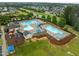 Community pool area with pool, pool house, lounge chairs, playground, and lush green landscaping at 850 Apalachia Lake Dr, Fuquay Varina, NC 27526