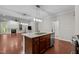Kitchen island with granite countertop, stainless steel appliances, and hardwood floors at 850 Apalachia Lake Dr, Fuquay Varina, NC 27526
