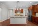 Modern kitchen features stainless steel appliances, granite countertops, custom cabinets, and seamless access to other rooms at 850 Apalachia Lake Dr, Fuquay Varina, NC 27526